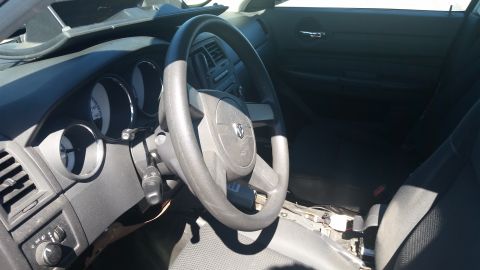 2001 Ford Crown Victoria - Interior view of a car, likely a Dodge, with the dashboard and steering wheel visible. Some parts appear to be removed.