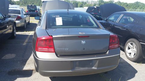 2001 Ford Crown Victoria - Rear view of a gray Dodge Charger parked in a lot with other vehicles.
