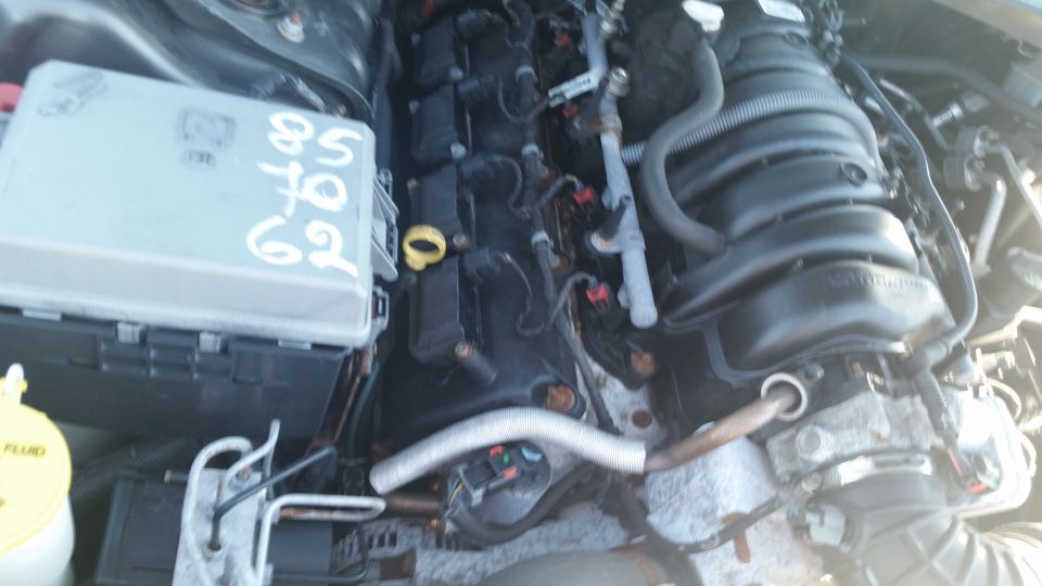 Engine bay with fuse box showing handwritten numbers 85 67 62