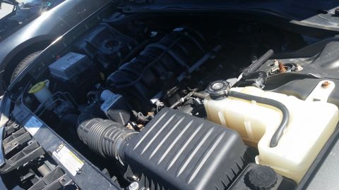 2001 Ford Crown Victoria - Close-up view of a car's engine bay, showing various mechanical parts.