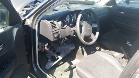 2001 Ford Crown Victoria - The interior of a car shows the dashboard, steering wheel, and seats, with some parts removed.
