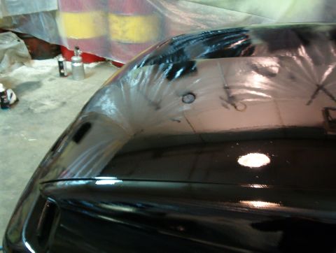 1990 Ford Taurus - A freshly painted car hood is shown, with spray cans and protective sheeting in the background.