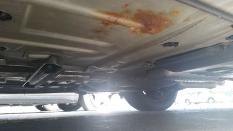 2001 Ford Crown Victoria - Underside view of a vehicle with visible rust and exhaust system components.