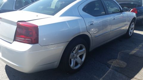 2001 Ford Crown Victoria - This silver sedan is viewed from the rear three-quarter angle, highlighting its unique taillight design.