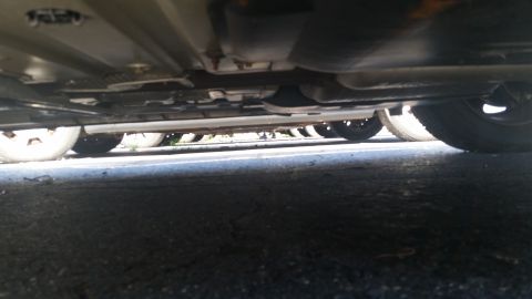 2001 Ford Crown Victoria - The underside of a car is visible, with multiple wheels and exhaust components in view.