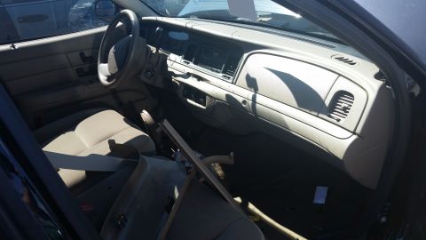 2001 Ford Crown Victoria - Interior view of a 2001 Ford Crown Victoria, revealing its tan dashboard and seating.