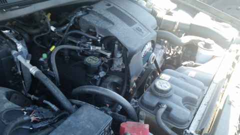 2001 Ford Crown Victoria - Close-up view of the engine bay, showing various mechanical parts and hoses.