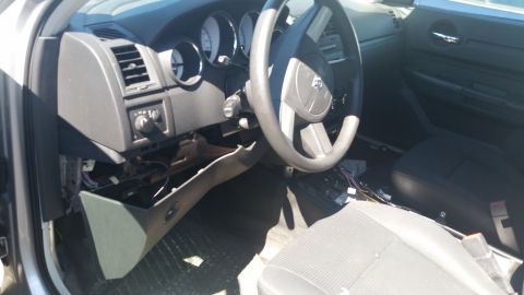 2001 Ford Crown Victoria - The interior of a car is visible, with the dashboard, steering wheel, and exposed wiring.