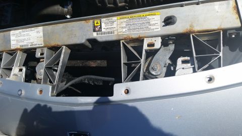 2001 Ford Crown Victoria - Photo of a vehicle front radiator support area, not a technical document.