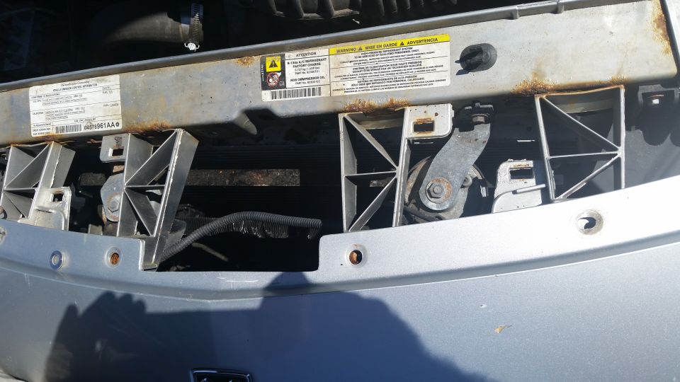 Radiator support and core area with caution decals visible