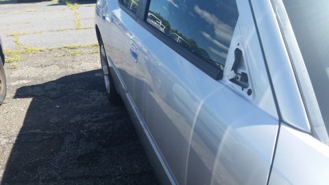2001 Ford Crown Victoria - Photo of a car side body panel, not a technical document.