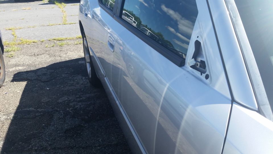 Side body panel and door of a silver Dodge Charger
