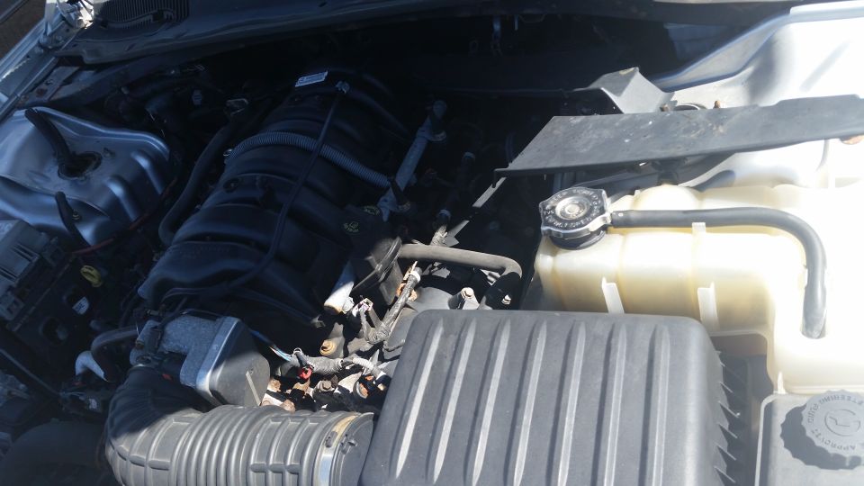 Engine bay with intake manifold, air box and coolant reservoir