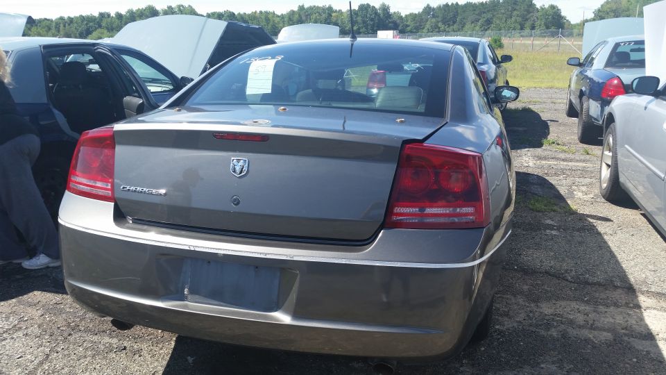 Rear view of a gray Dodge Charger sedan in a lot