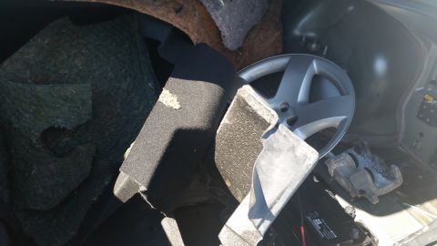2001 Ford Crown Victoria - Photo of disassembled car parts inside a vehicle, not a technical document.