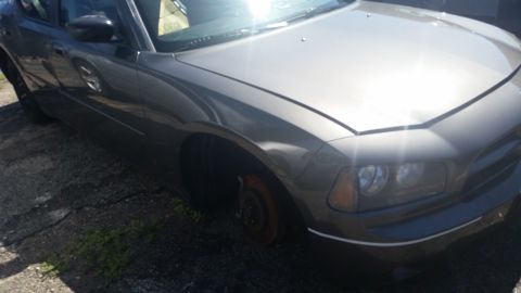 2001 Ford Crown Victoria - Photo of a car front fender and bare hub, not a technical document.