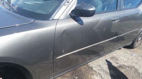 2001 Ford Crown Victoria - Photo of a car side door and mirror, not a technical document.