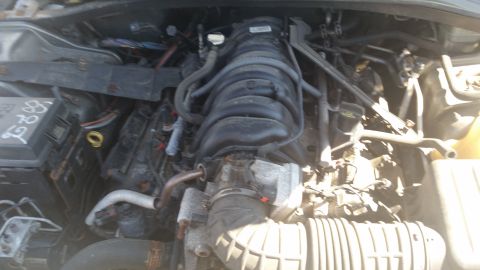 2001 Ford Crown Victoria - Photograph of a V6 engine bay with intake manifold and hoses, not a technical document.