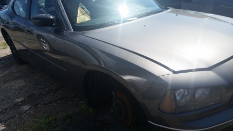 2001 Ford Crown Victoria - Photograph of the front quarter of a silver Dodge Charger sedan, not a technical document.