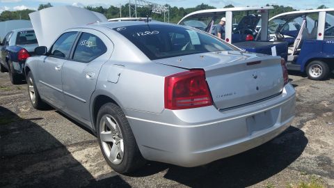 2001 Ford Crown Victoria - Photograph of the rear quarter of a silver Dodge Charger at auction, not a technical document.