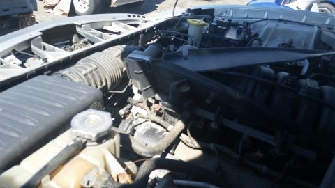 2001 Ford Crown Victoria - Photograph of an engine bay showing air intake tubing and fluid reservoirs, not a technical document.