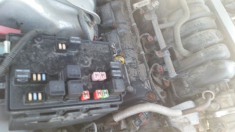 2001 Ford Crown Victoria - Photograph of a physical underhood fuse and relay box with relays installed, not a document or chart.
