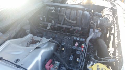 2001 Ford Crown Victoria - Photograph of an engine bay showing the intake manifold and underhood fuse box, not a technical document.