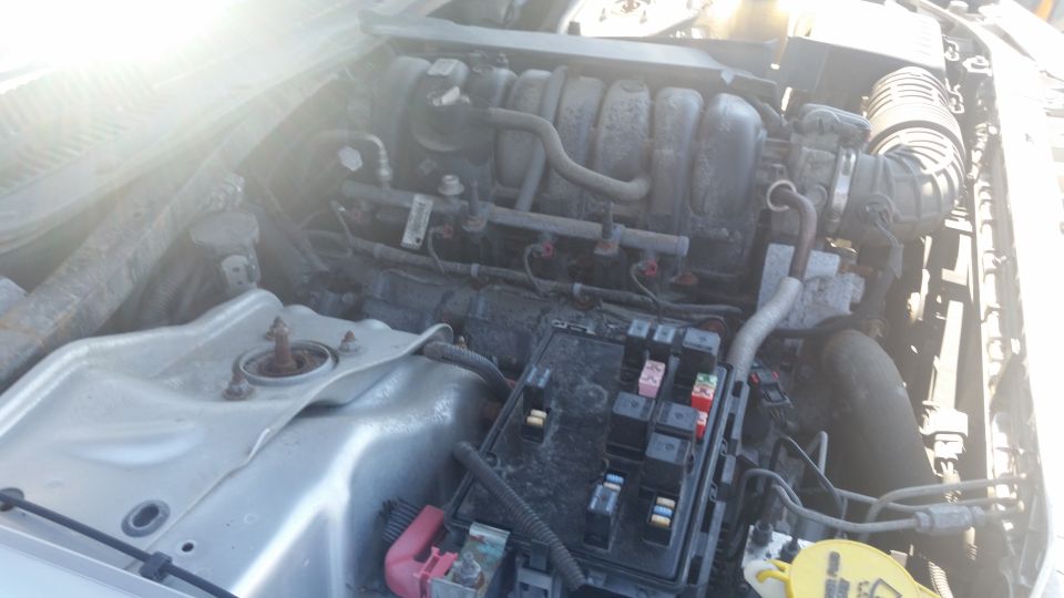 Engine bay photo with intake manifold and fuse box