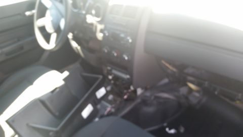 2001 Ford Crown Victoria - Blurry photograph of a vehicle interior and dashboard with components removed, not a technical document.