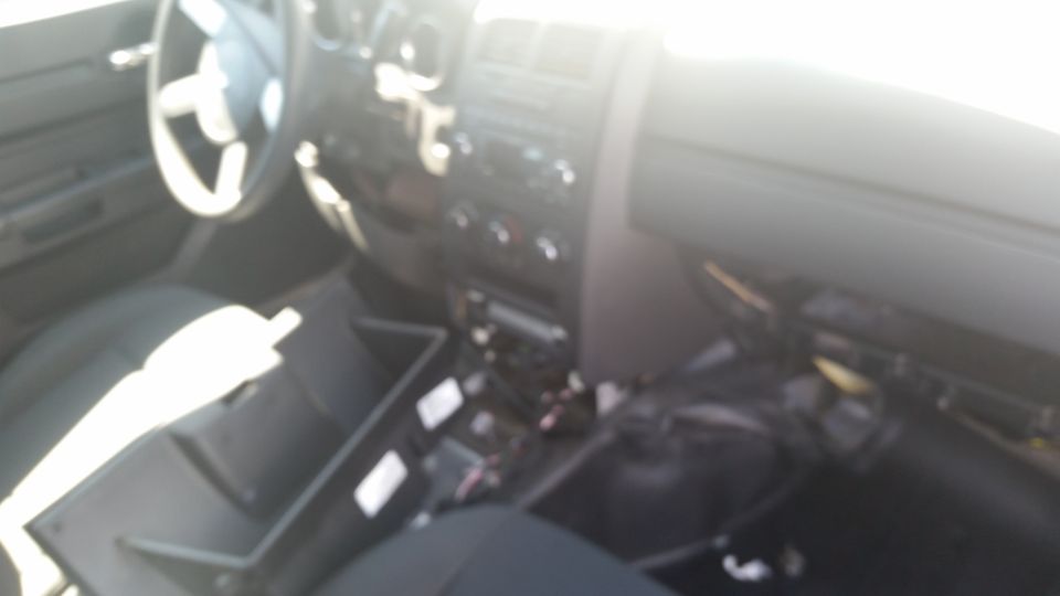 Blurry photo of a car interior dashboard