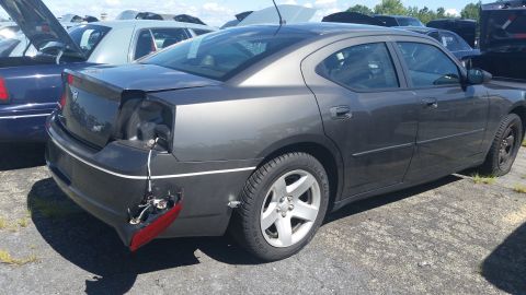 2001 Ford Crown Victoria - Photograph of the damaged rear quarter of a gray Dodge Charger at a salvage auction, not a technical document.
