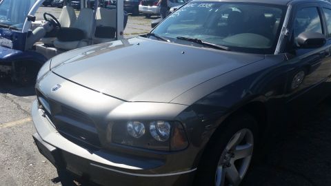 2001 Ford Crown Victoria - Photograph of the front quarter of a gray Dodge Charger at a salvage auction, not a technical document.