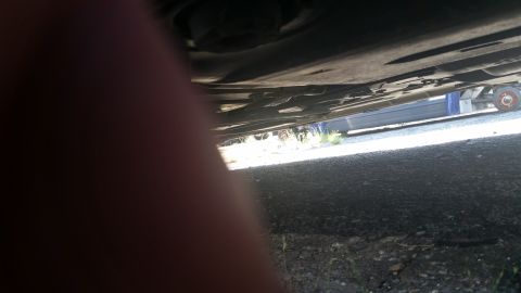 2001 Ford Crown Victoria - Photograph taken underneath a vehicle showing the undercarriage and pavement, not a technical document.