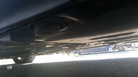 2001 Ford Crown Victoria - Photograph of a vehicle undercarriage viewed from below, not a technical document.
