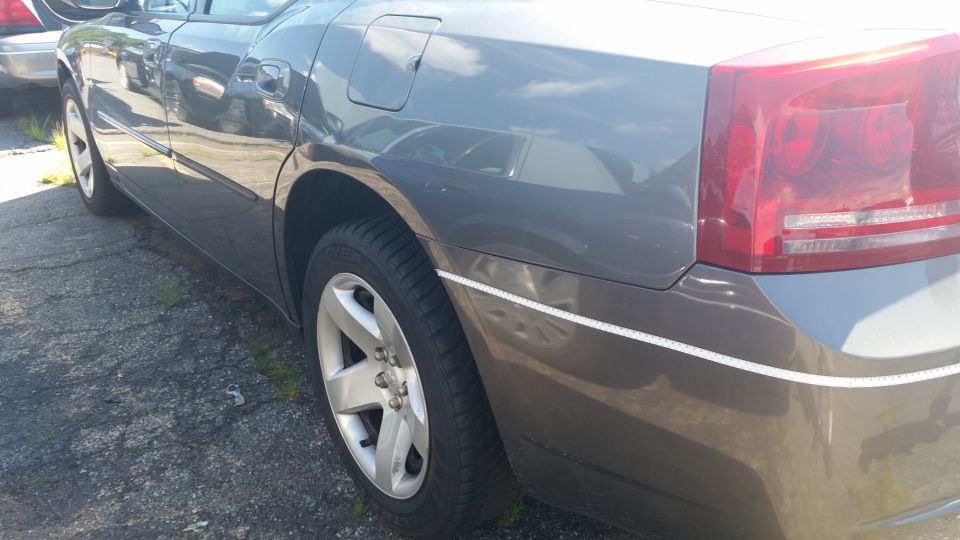 Rear quarter panel and taillight of a gray Dodge Charger