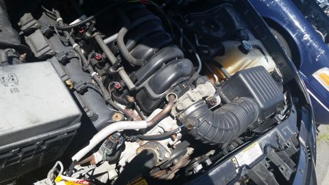 2001 Ford Crown Victoria - Photo of a Dodge Charger engine compartment showing intake manifold and air intake duct.