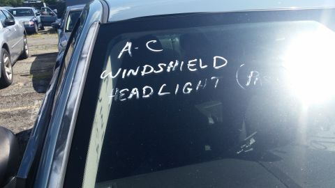2001 Ford Crown Victoria - Photo of a vehicle windshield marked in white grease pencil reading A-C, windshield, headlight.