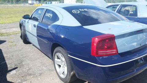 2001 Ford Crown Victoria - Photo of the rear of a two-tone blue Dodge Charger with grease-pencil number 965 in a salvage lot.
