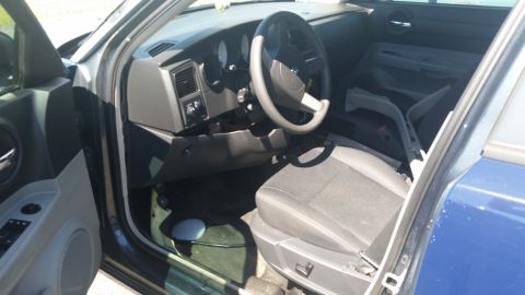 2001 Ford Crown Victoria - Photo of a Dodge Charger interior showing steering wheel, dashboard, and front seat.
