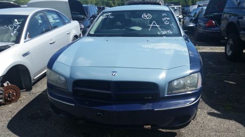 2001 Ford Crown Victoria - Photo of the front of a light blue Dodge Charger with grease-pencil markings in a salvage yard.