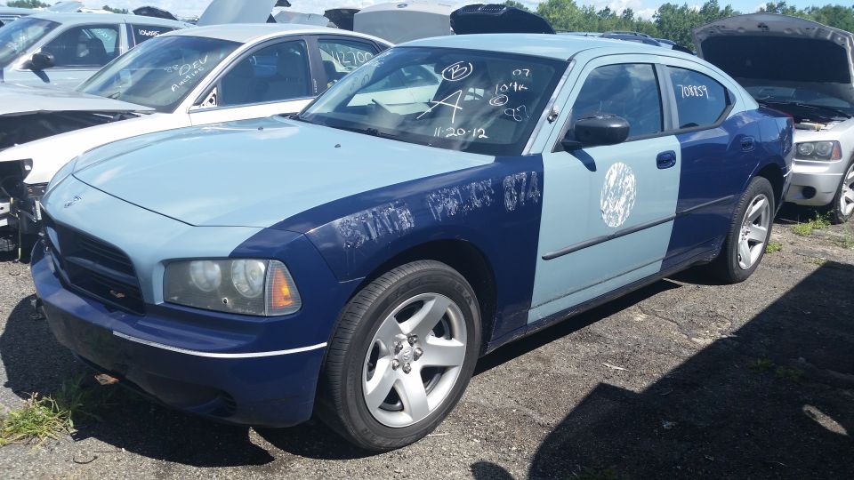 Front corner of a two-tone blue Dodge Charger with marker codes