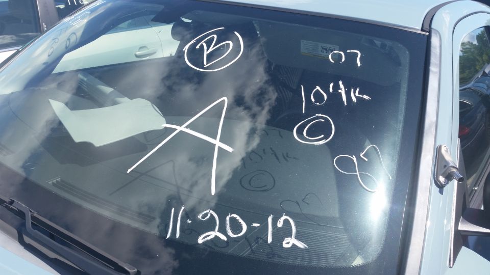 Windshield with grease-pencil markings B A 07 and a date