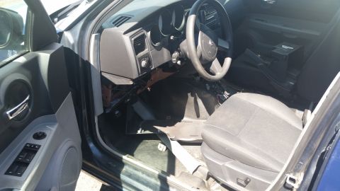 2001 Ford Crown Victoria - Photo of a Dodge Charger interior showing steering wheel, dashboard, and front seat.
