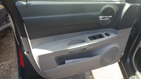 2001 Ford Crown Victoria - Photo of the interior driver door panel of a Dodge Charger with window switches and handle.