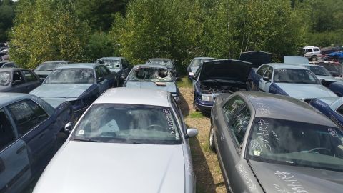2001 Ford Crown Victoria - Photo of marked salvage vehicles parked in an outdoor yard, not a document.