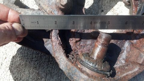 1996 Ford Bronco - A close-up shot shows a rusty metal part with a ruler measuring approximately 2.5 inches. The ruler has markings in inches and millimeters,…