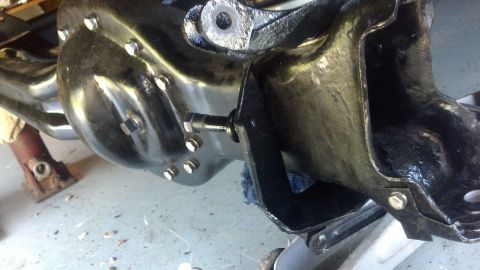 1996 Ford Bronco - A black painted differential housing with multiple bolts is shown. A metal bracket is attached to the housing with a bolt and nut.