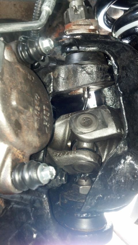 1996 Ford Bronco - A close-up view of the suspension and drivetrain components of a 1996 Ford Bronco. Visible parts include a ball joint, U-joint, brake calip…