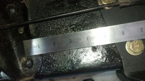 1996 Ford Bronco - A metal ruler is placed over a black, textured surface, possibly a vehicle part. The ruler shows measurements in inches and centimeters, wi…