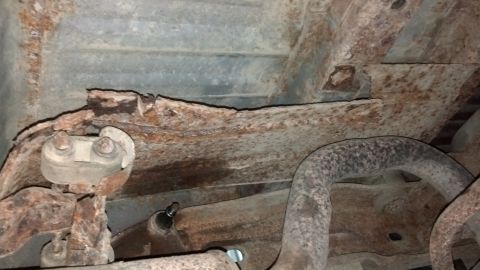 1996 Ford Bronco - The heat shield above the muffler was only hanging on by the rust. I barely pulled on it and it broke loose. In this pic, I had pushed it b…